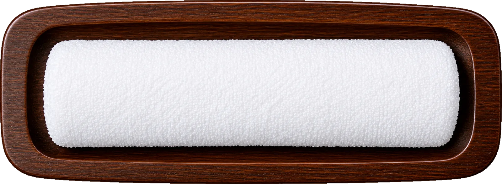 A rolled white oshibori towel resting in a dark wooden tray.